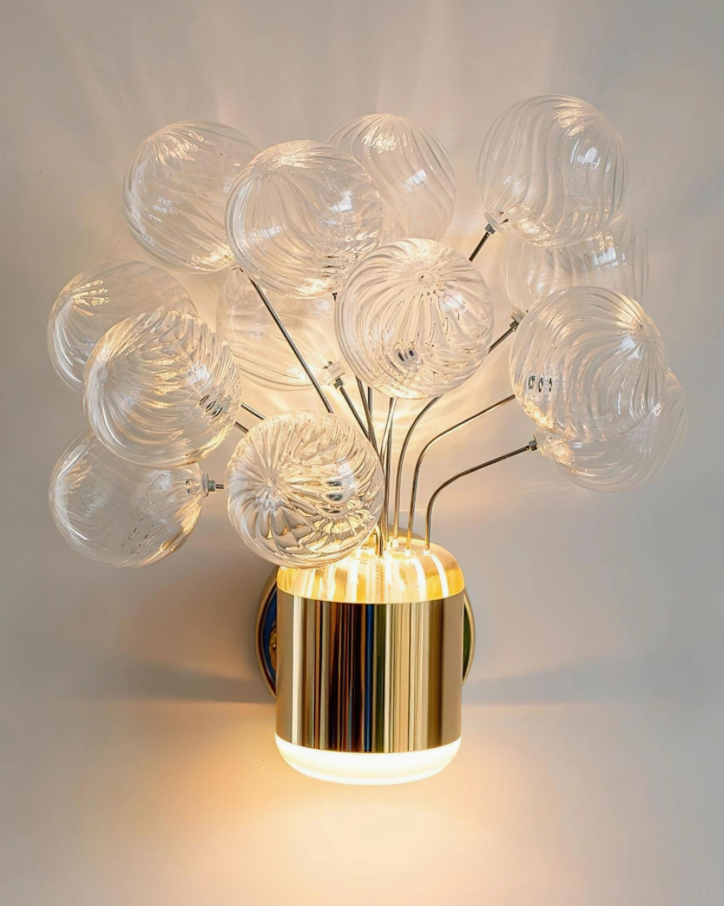 Overhead front view of lit Balloon Bouquet Wall Sconce showing clear glass spheres with warm light emanating from gold base