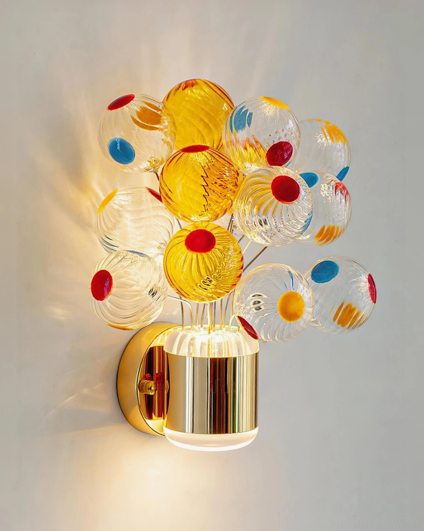 Close-up of Balloon Bouquet Wall Sconce with warm white LED illumination and colorful dotted glass balloons against neutral wall