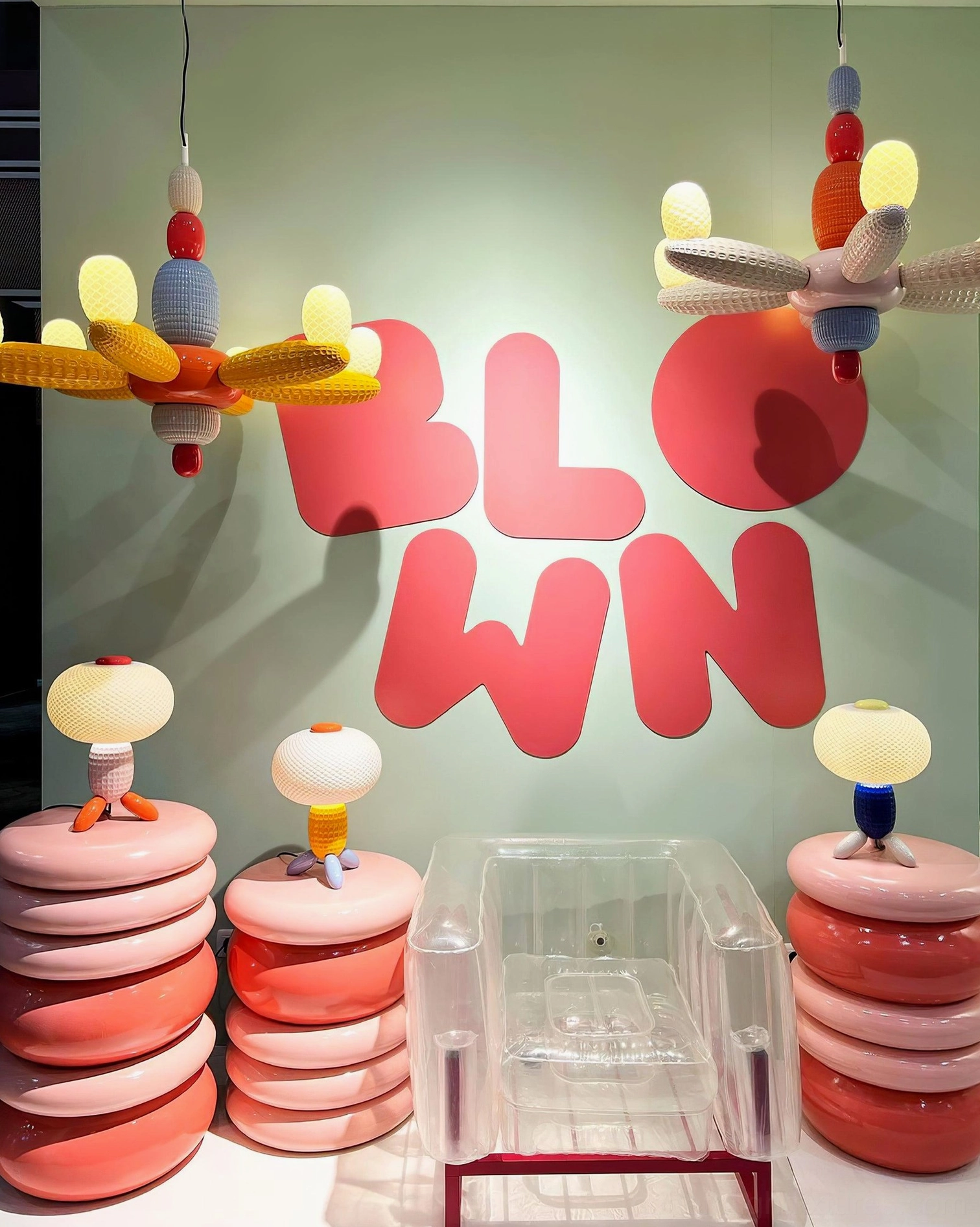 Balloon chandelier displayed in modern showroom with matching table lamps and contemporary décor