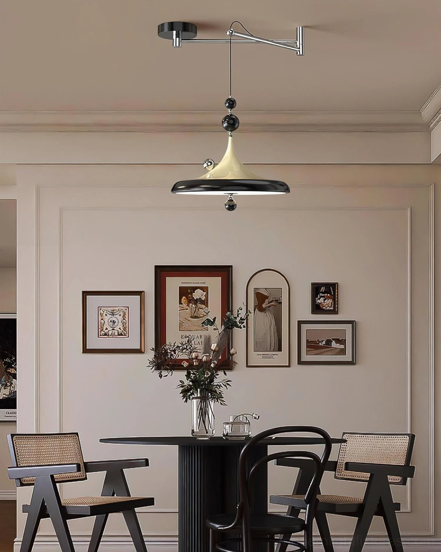 Black accent Ballora pendant light in minimalist dining space with gallery wall, eye-level perspective showing mid-century modern aesthetic