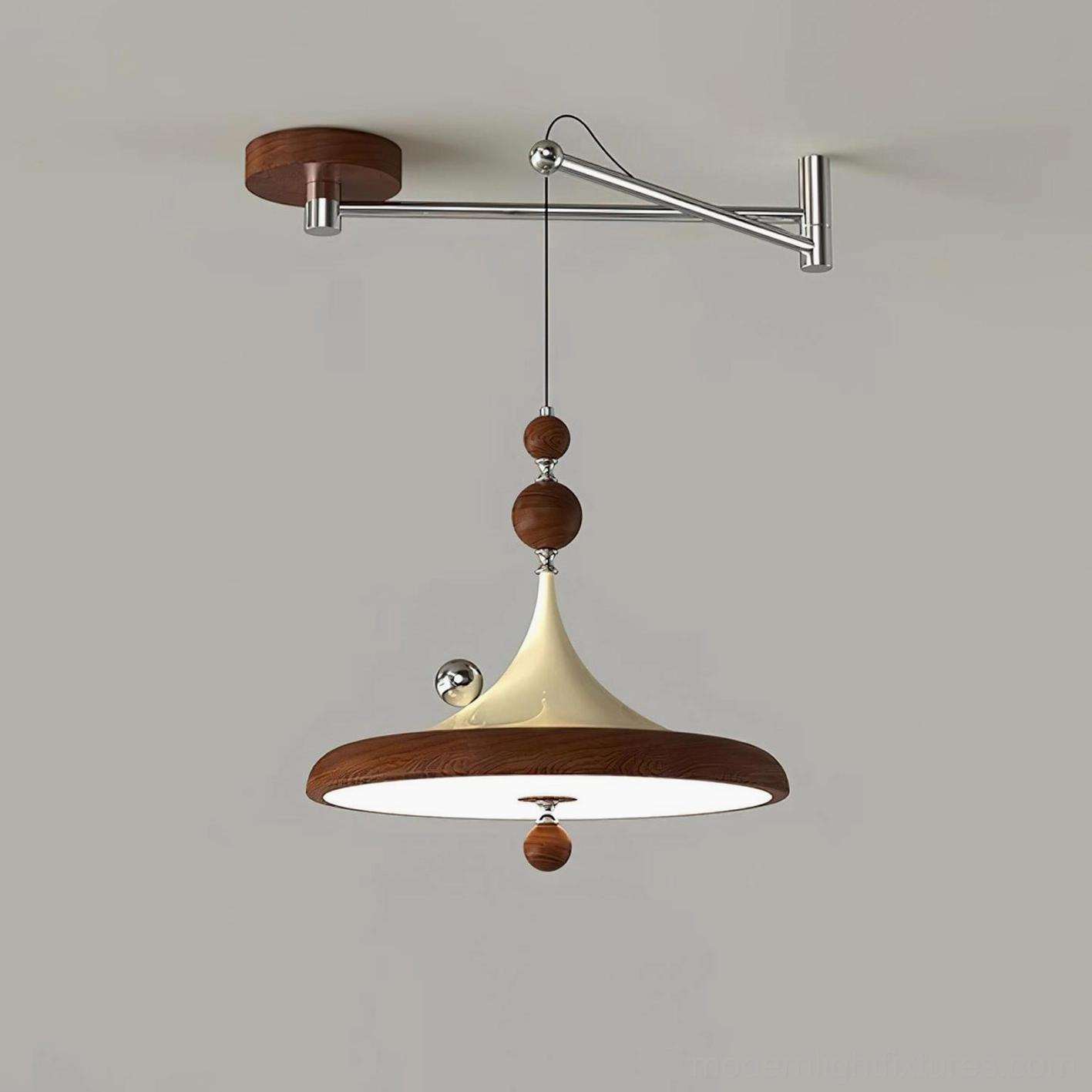 Walnut and beige Ballora swing arm pendant light side profile, studio backdrop showcasing sculptural form and decorative beads