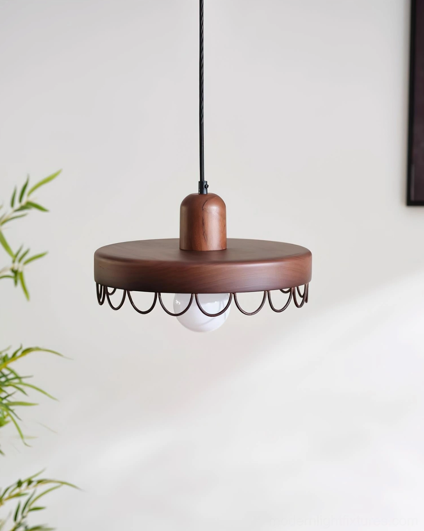 Walnut finish Balton pendant light with black scalloped metal trim and glowing bulb against studio white background