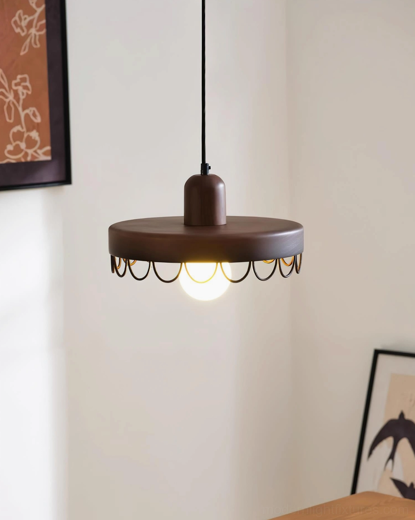 Dark walnut wooden pendant light with black metal trim and illuminated exposed bulb in home office workspace