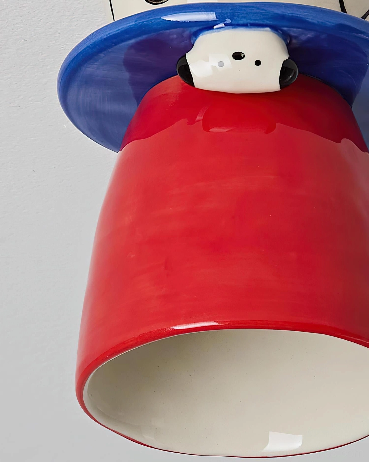 Bambino ceramic ceiling light close-up detail - handcrafted sculptural puppy design with vibrant color palette