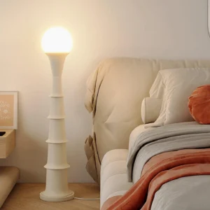 White minimalist bamboo joint floor lamp in bedroom bedside setting, soft warm ambient lighting with tiered cylindrical structure