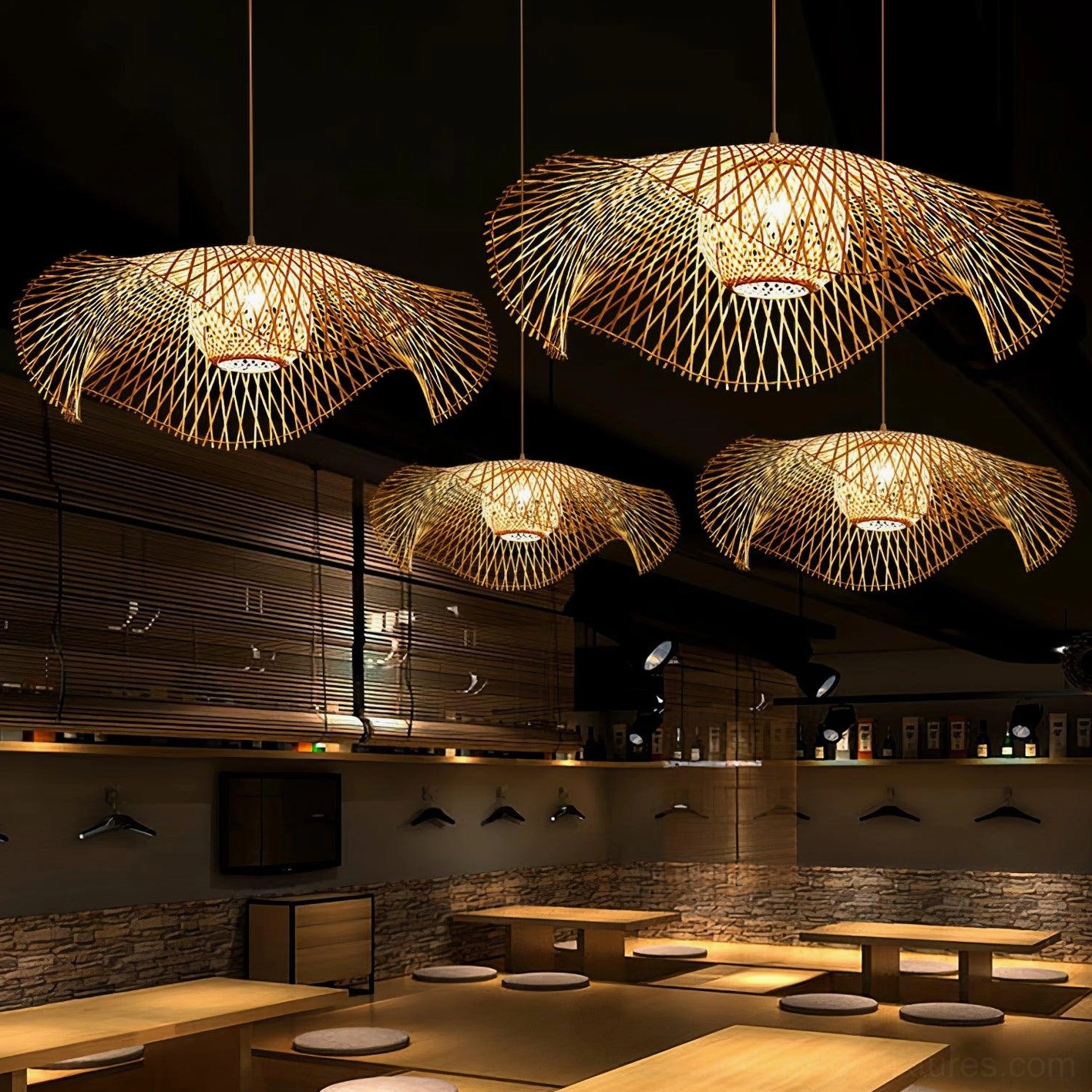 Bamboo lotus leaf pendant lamp creating dramatic lighting effect in modern home interior with warm glow