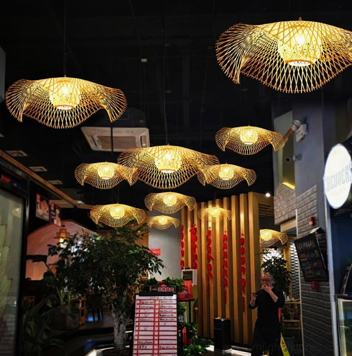 Bamboo lotus leaf pendant lamp from side angle showing three-dimensional woven texture and sculptural organic design