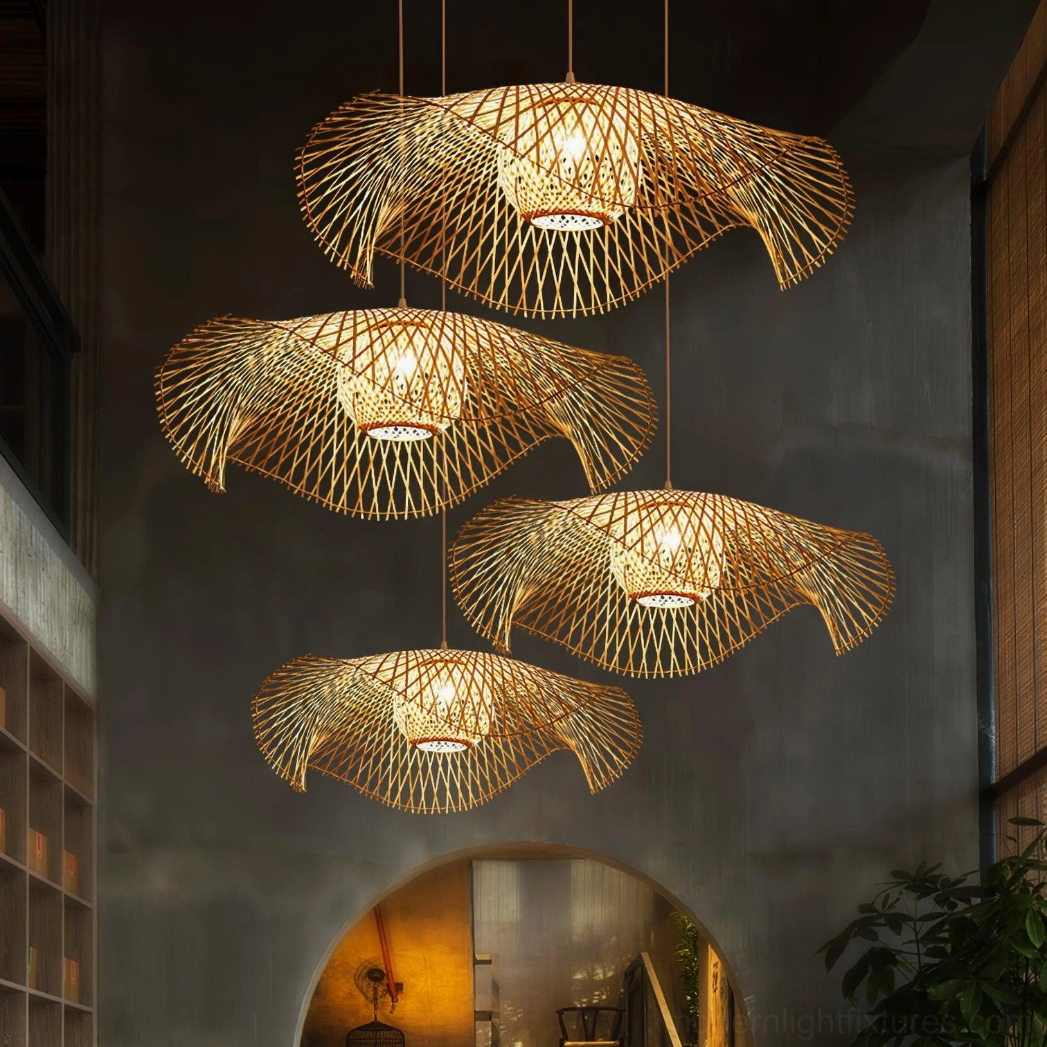 Multiple natural bamboo lotus leaf pendant lights clustered together in dark vintage dining space with warm glow, low-angle front view