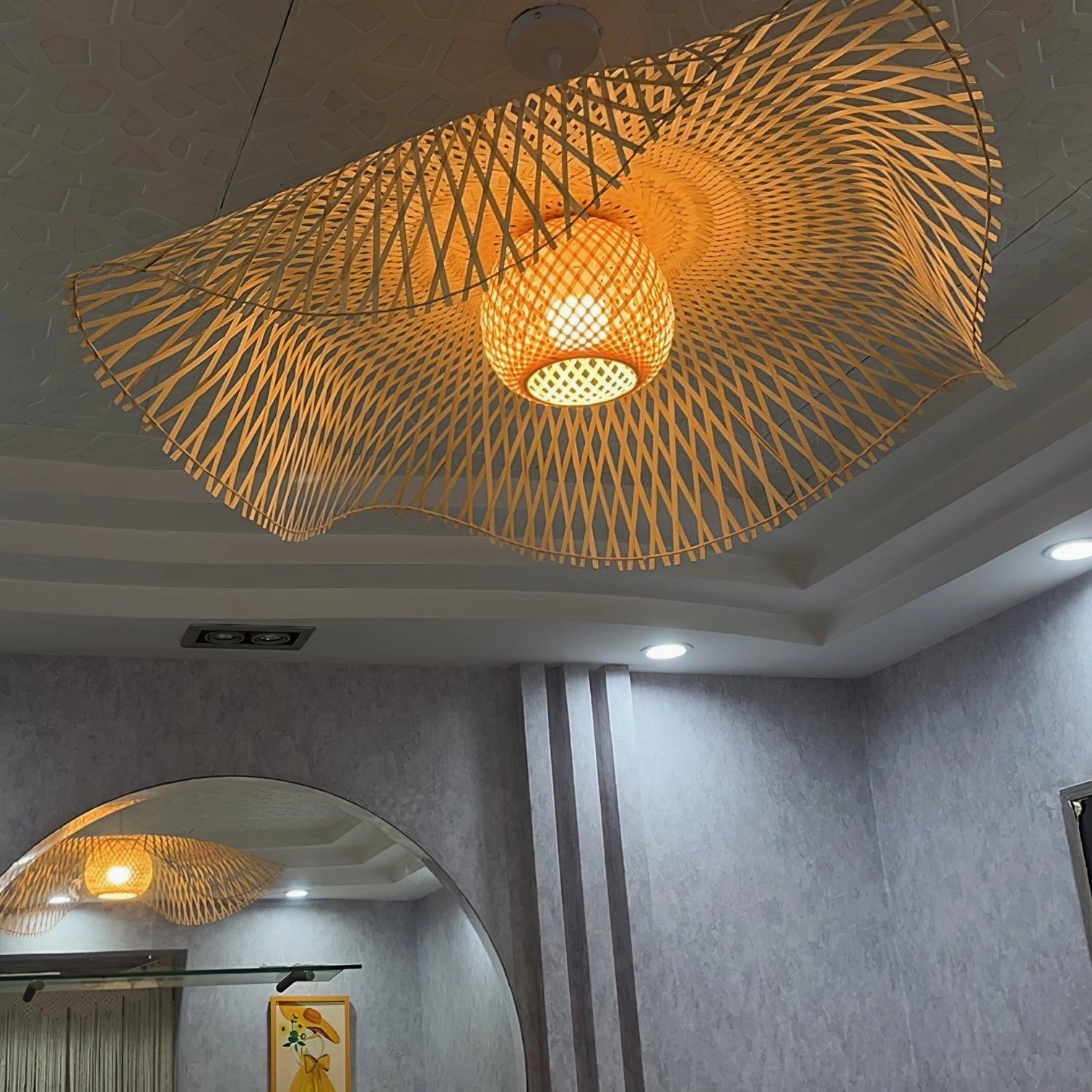 Bamboo lotus leaf pendant light installed in stylish interior space demonstrating warm ambient glow and organic shadow patterns