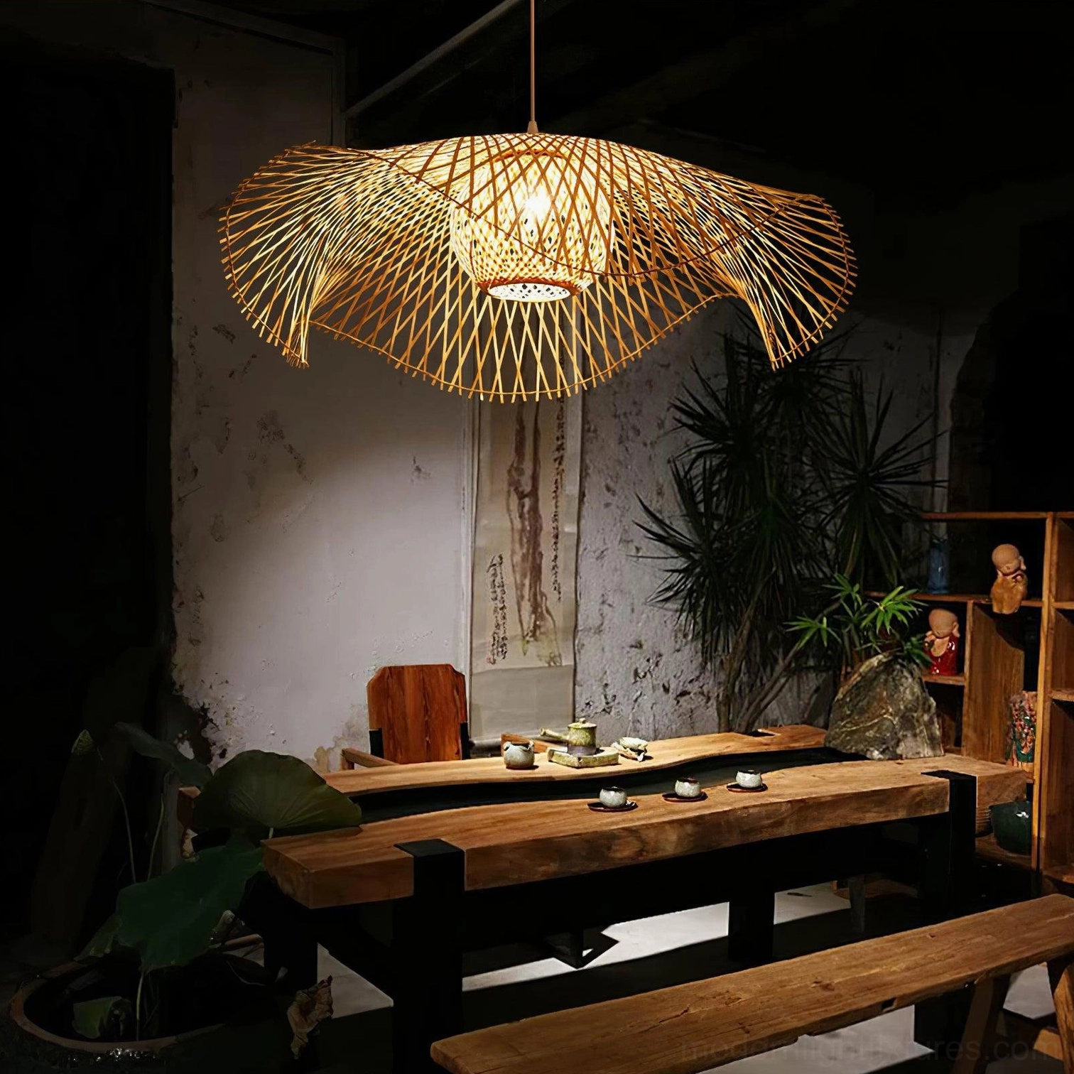 Natural bamboo lotus leaf pendant light in vintage tea room setting with rustic wabi-sabi style against dark worn wall background