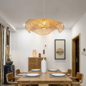 Handcrafted bamboo lotus leaf pendant lamp hanging in residential dining room with three-quarter overhead view, warm ambient lighting