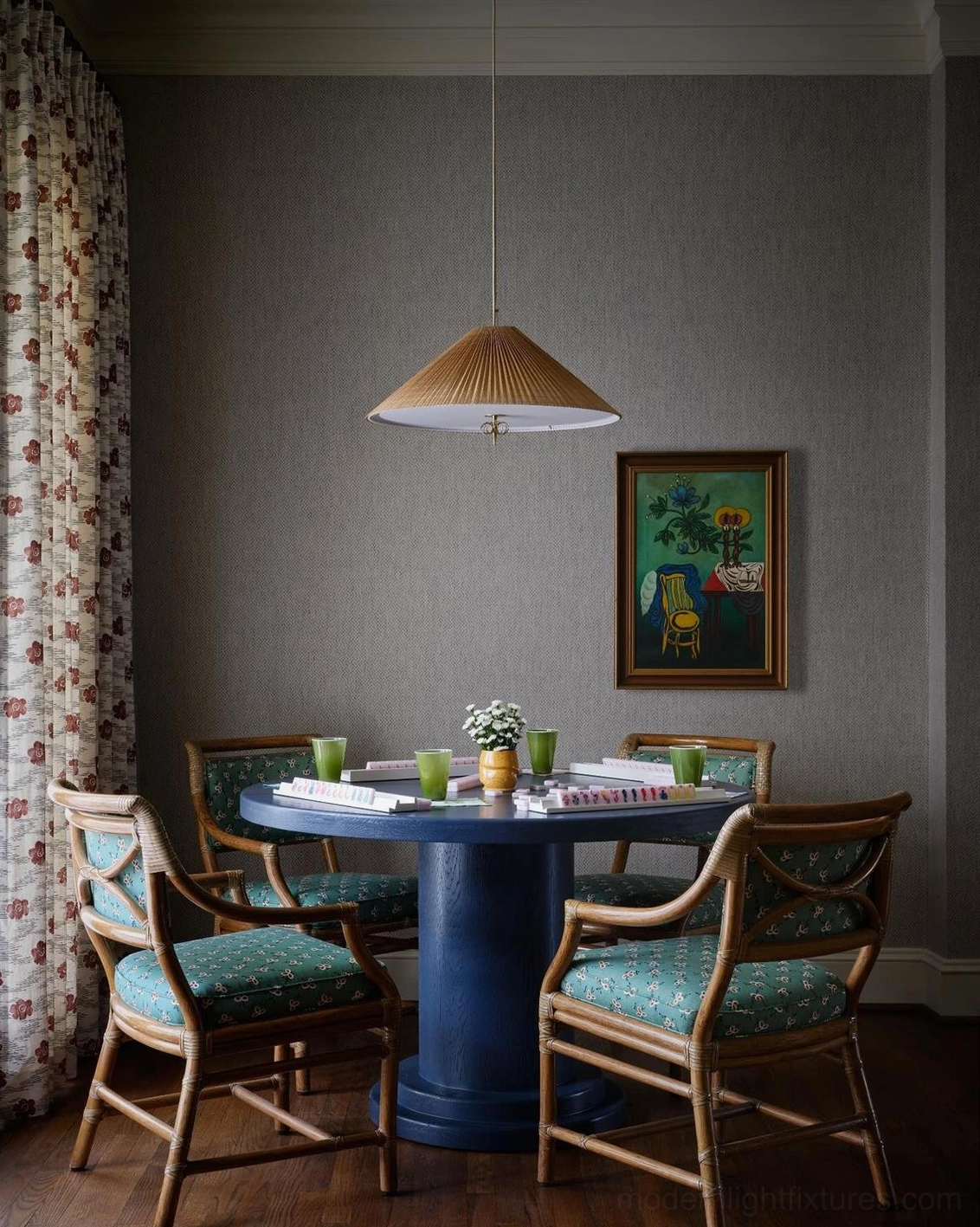 Small bamboo conical pendant light hanging above vintage blue dining table in cozy dining room