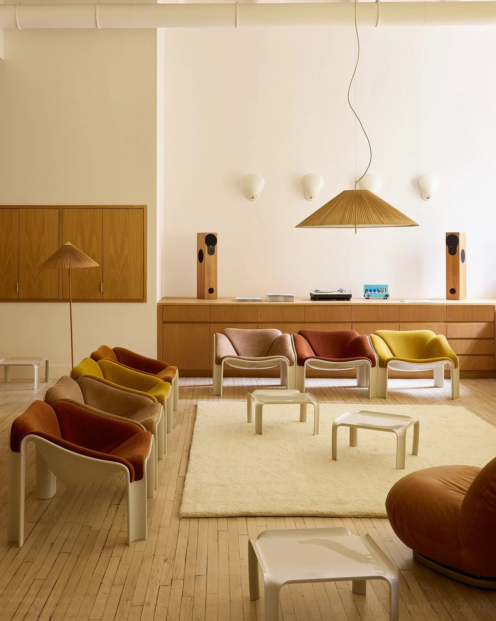 Wide conical bamboo pendant light in mid-century modern open living space with wood-toned interior design