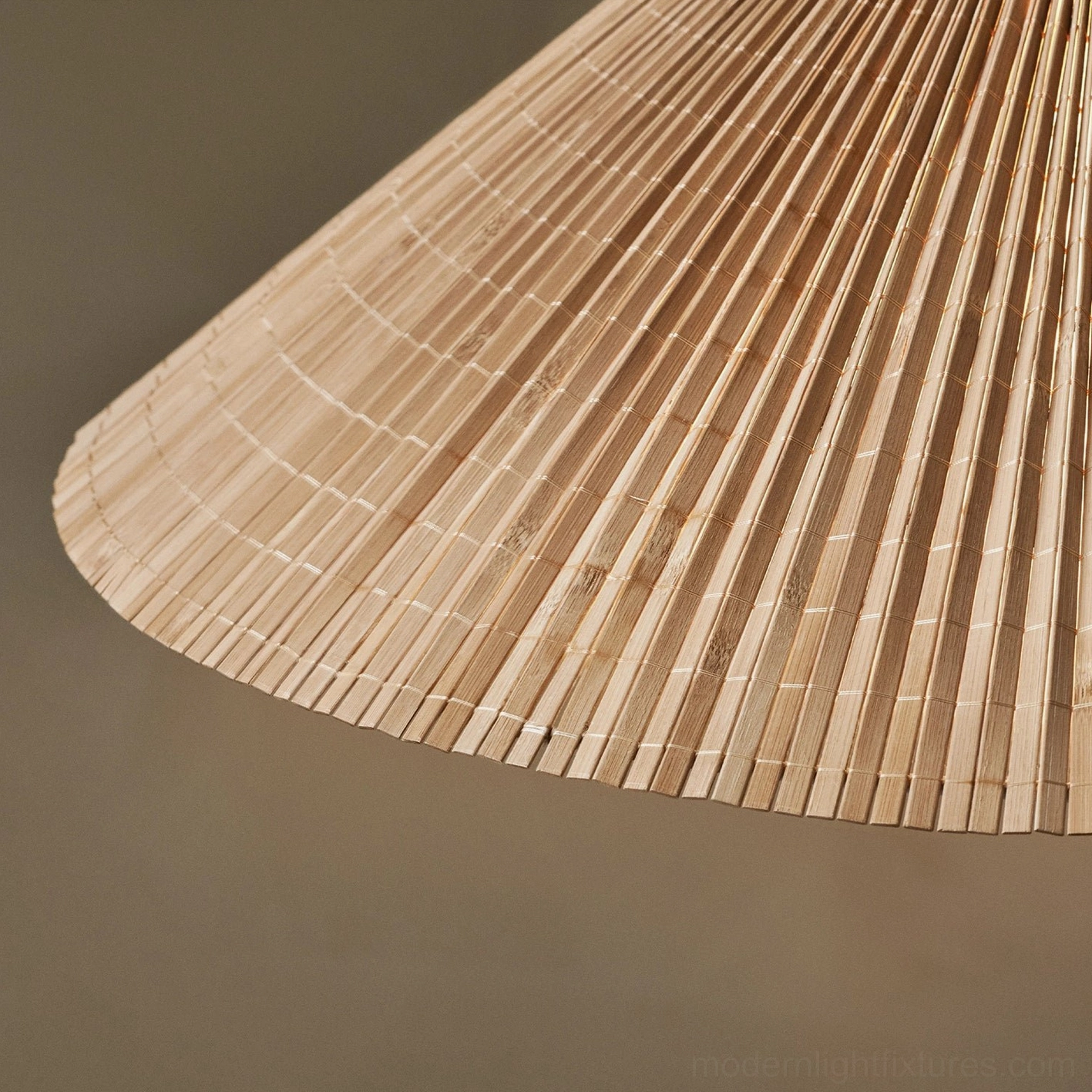 Mid-century modern bamboo pendant light with brass accents in transitional interior design setting