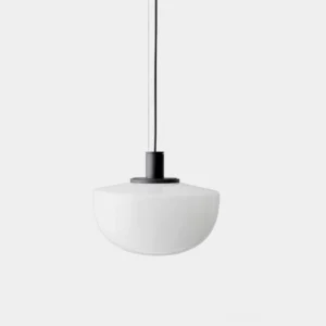 Bank mouth-blown glass pendant light with white opal dome and black aluminum hardware on studio background