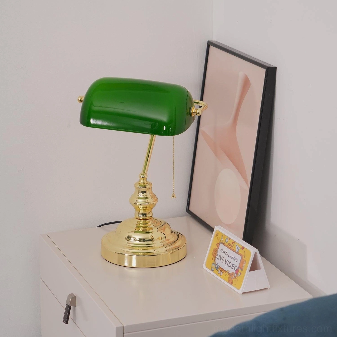 Banker table lamp close-up detail polished gold hardware and glass shade
