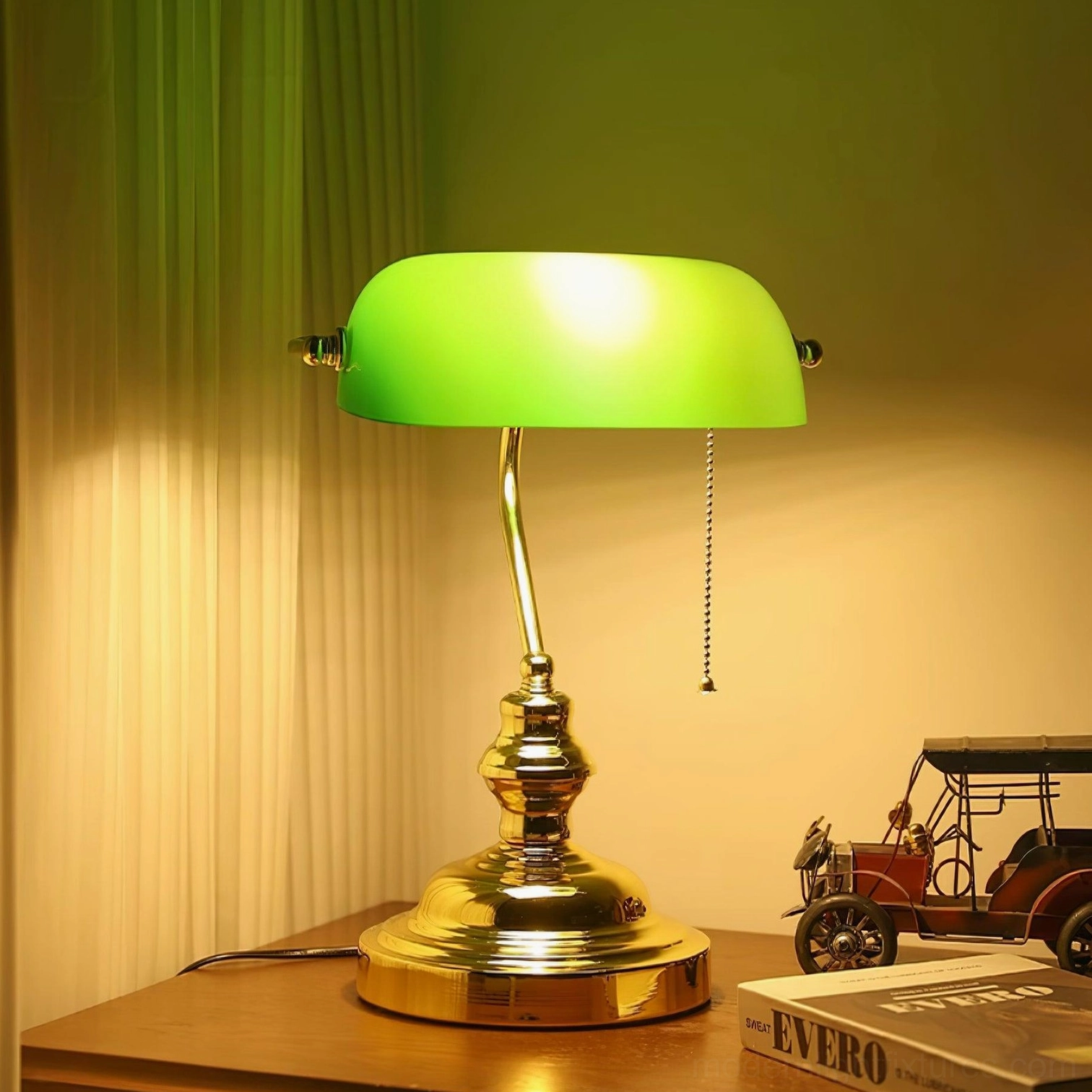 Banker table lamp with glowing green glass shade and gold base warm ambient lighting