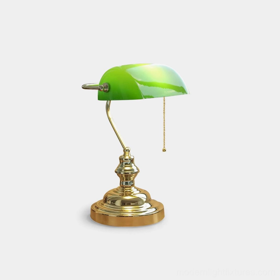 Classic vintage banker table lamp with green glass shade and polished gold metal base on white background