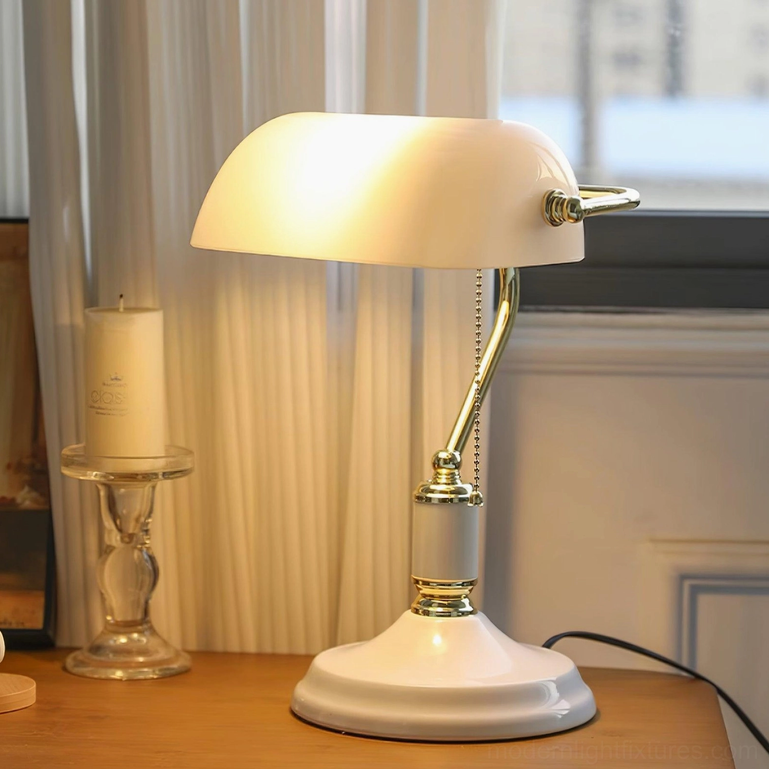 Classic banker table lamp with white glass shade and gold metal arm on windowsill table