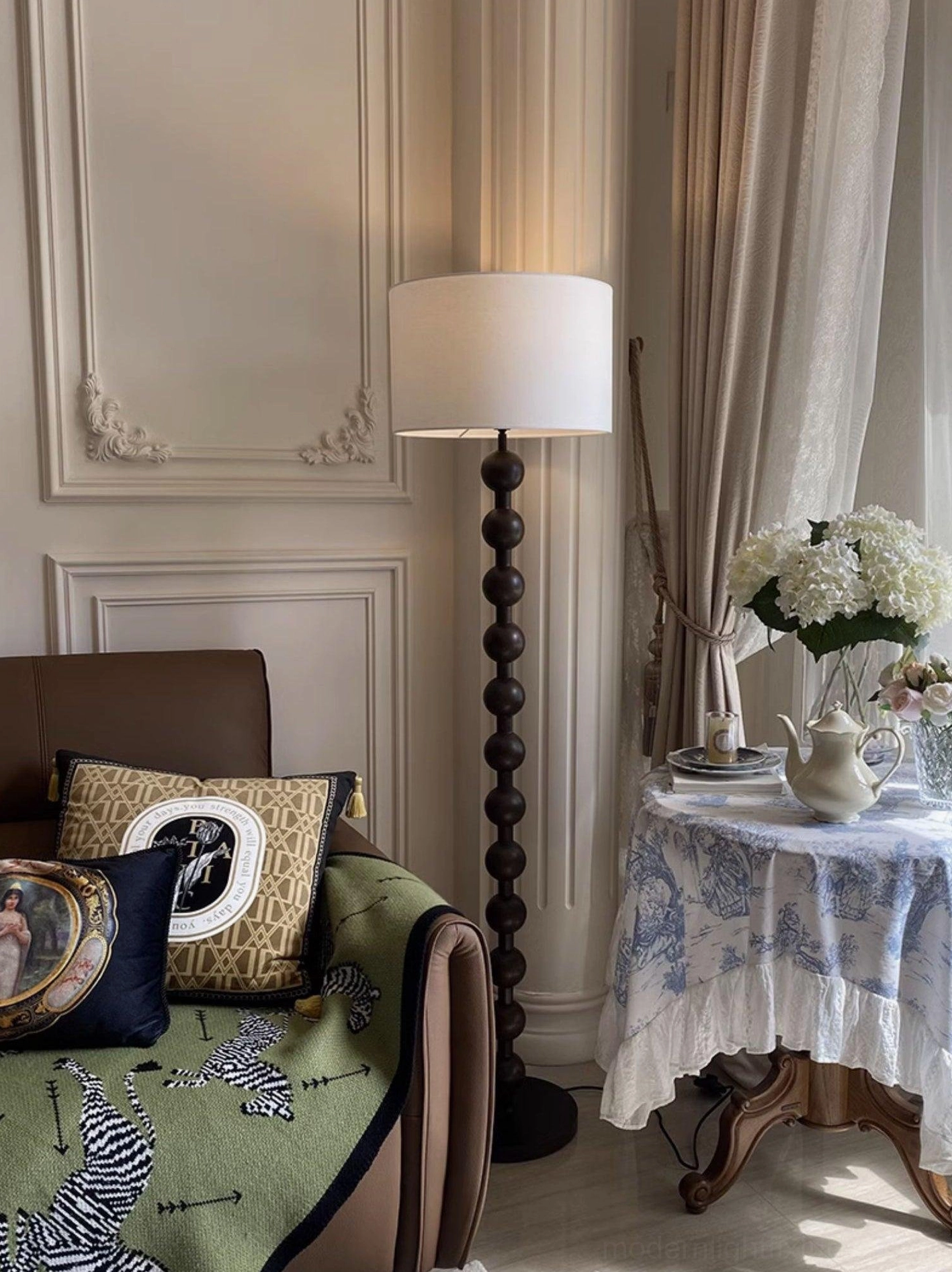 Walnut barbell floor lamp beside contemporary sofa and side table