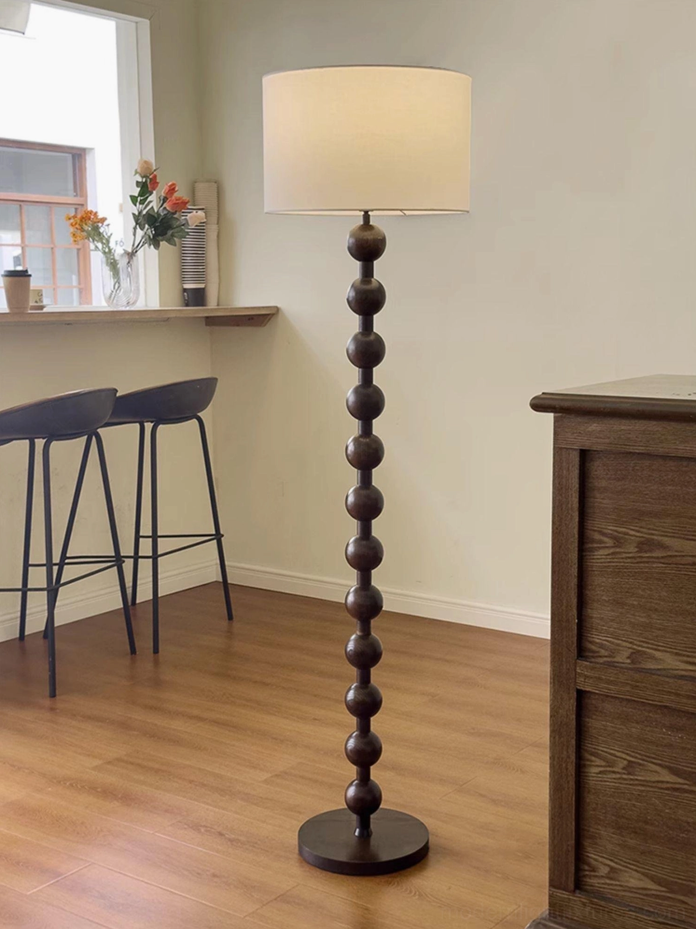 Natural wood barbell floor lamp showing hand turned sphere construction