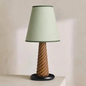 Twisted wood table lamp with sage green tapered empire shade and contrasting dark green trim, three-quarter perspective