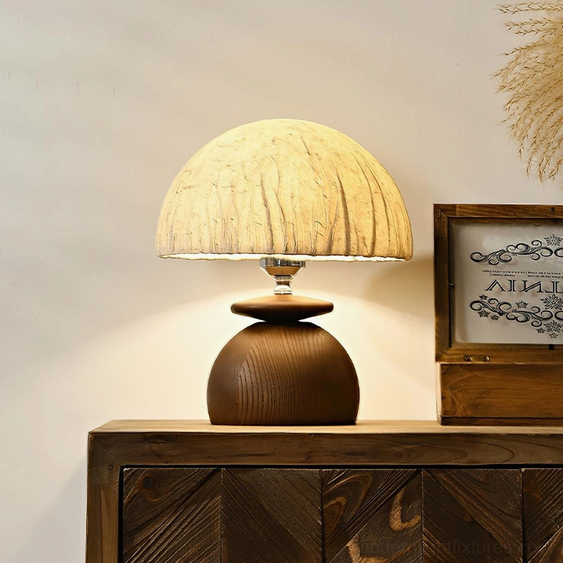Illuminated Basira table lamp creating warm ambient lighting on bedroom nightstand with vintage decor