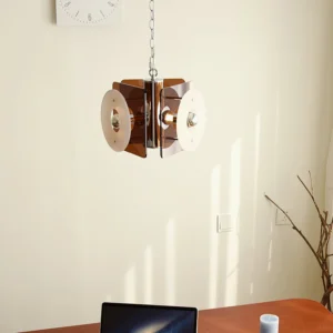 Basira pendant lamp installed in contemporary home office with wooden desk warm acrylic lighting