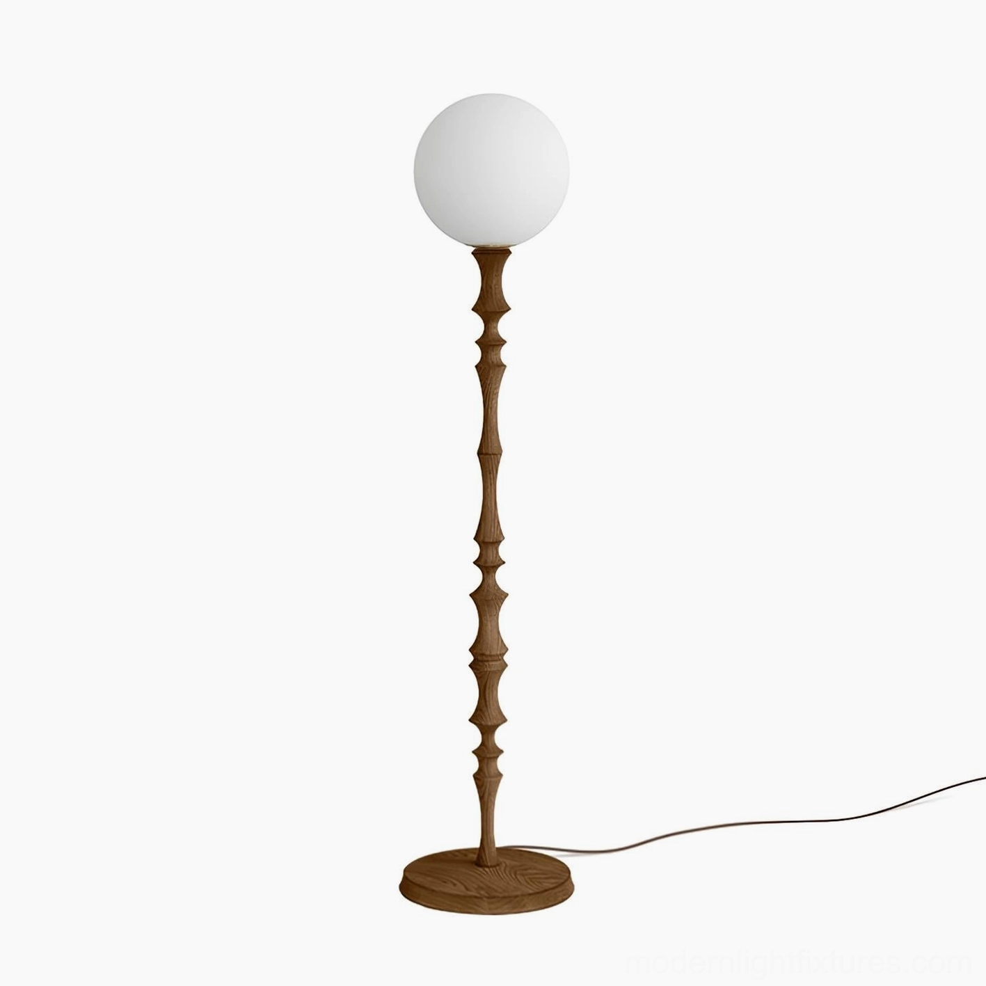 Bastino sculptural floor lamp showing rhythmic contours of carved wooden stem and soft light diffusion