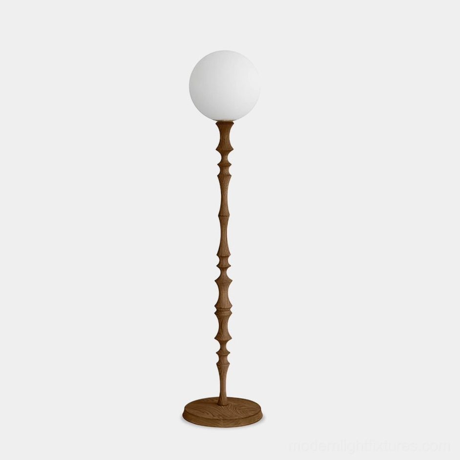 Bastino sculptural floor lamp with hand-carved wooden stem and frosted glass globe shade front view