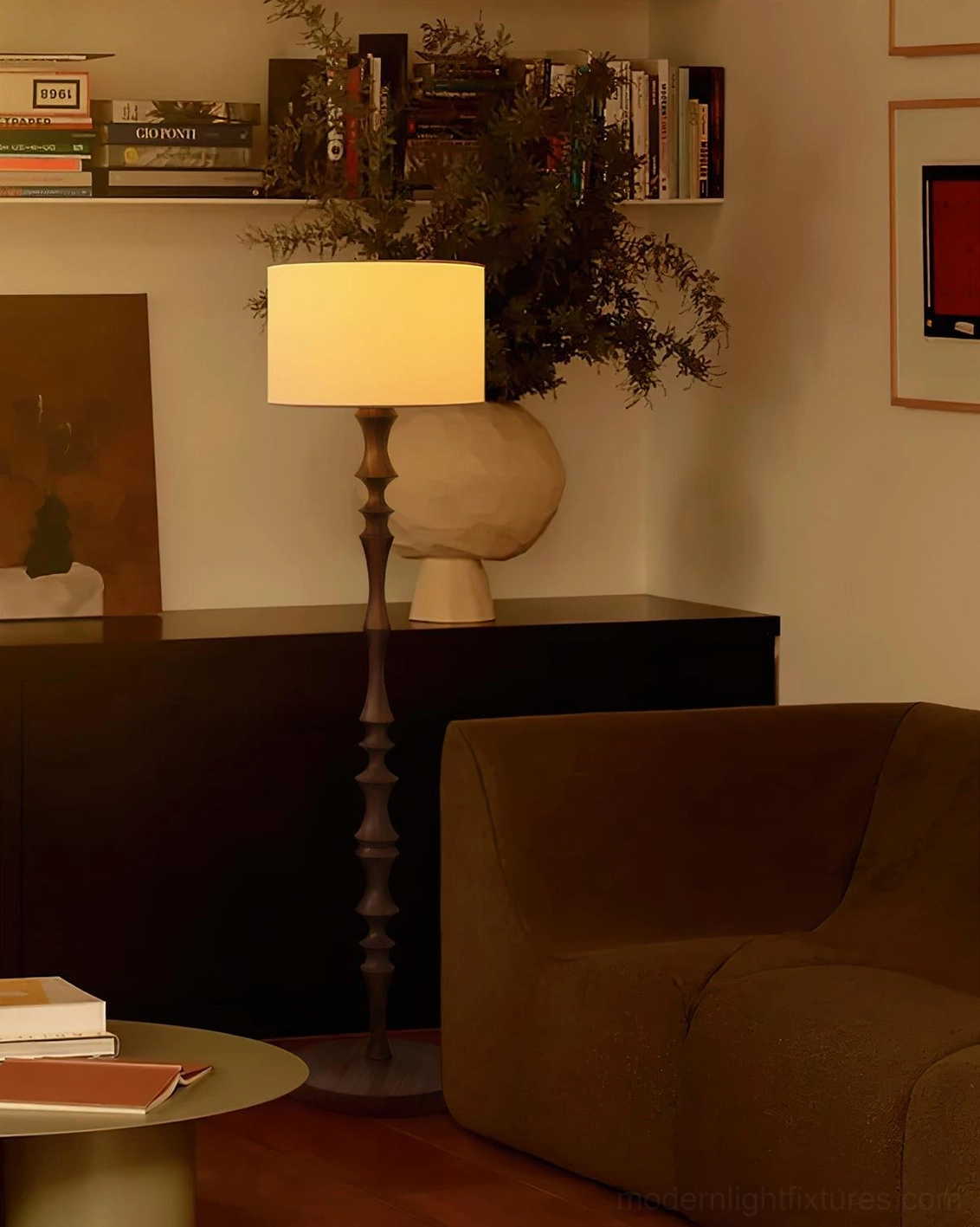 Dark carved wood Bastino floor lamp with beige fabric shade in home office study space