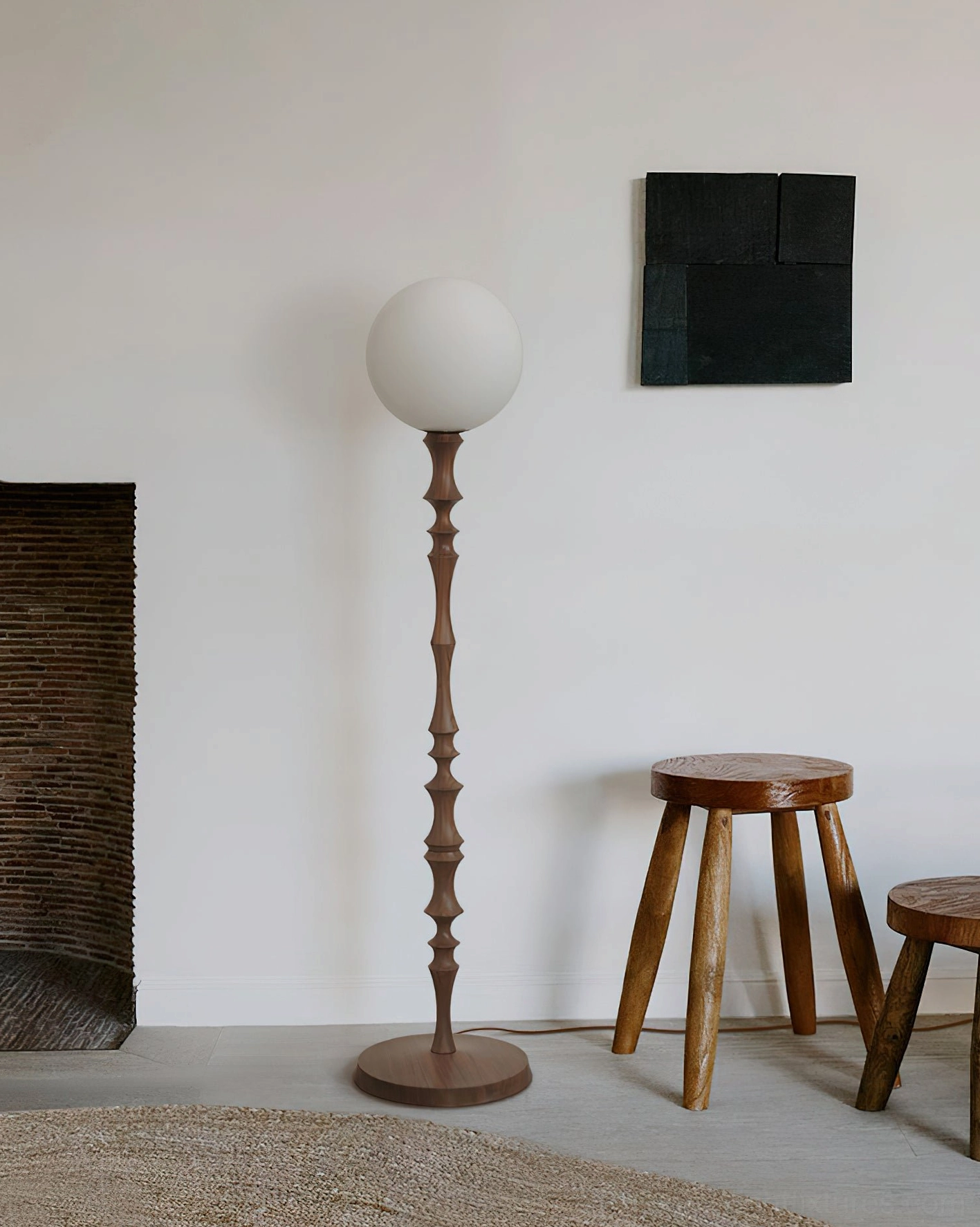 Bastino sculptural floor lamp with frosted white shade and turned wood pole in minimalist interior