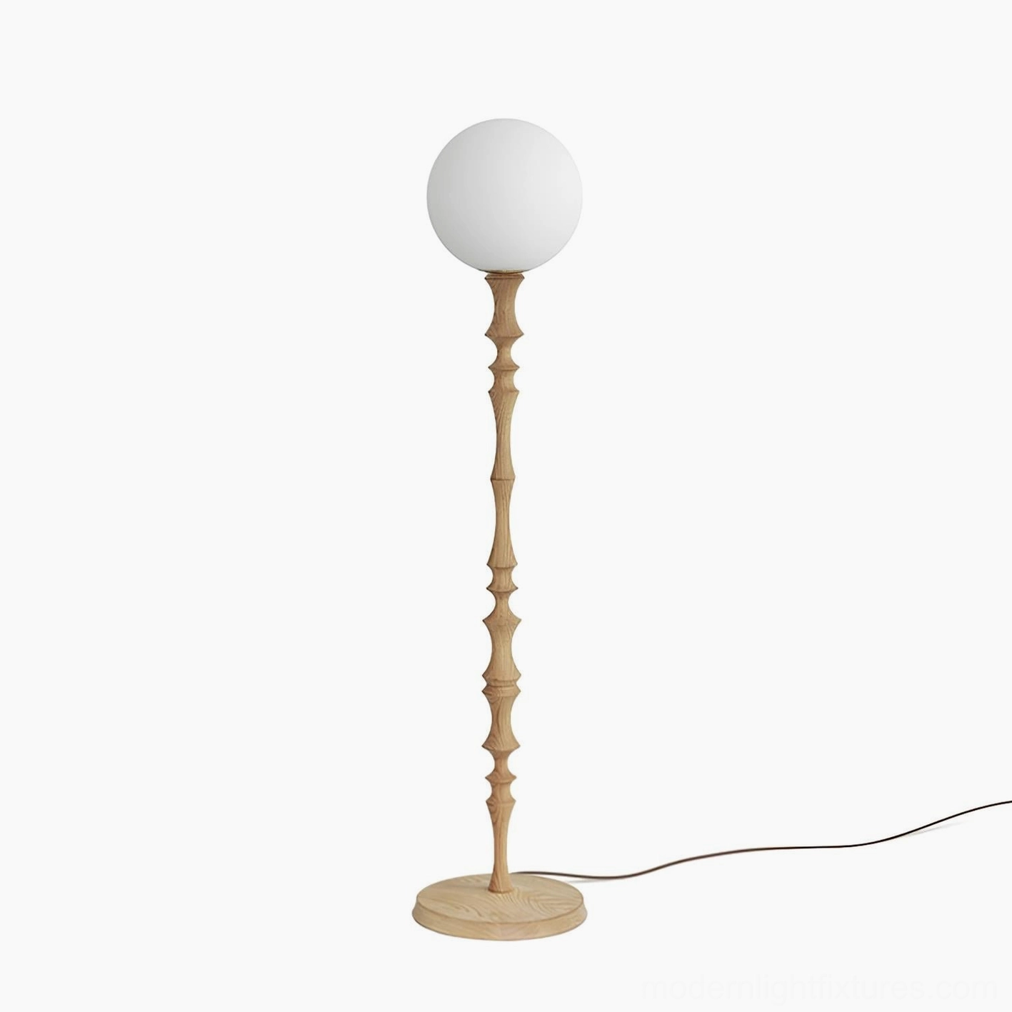 Bastino sculptural floor lamp with carved wooden pole and spherical frosted glass shade detail