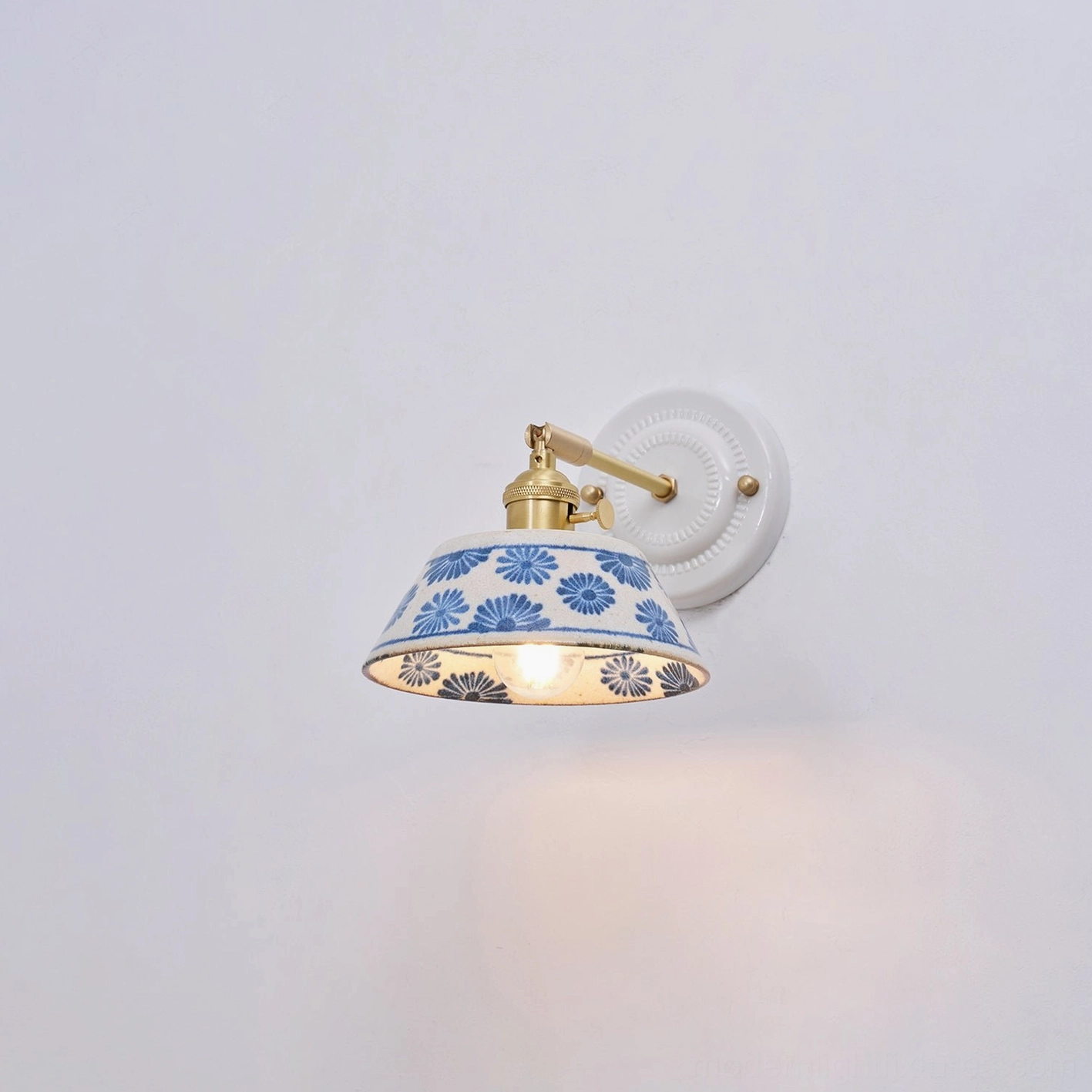 Contemporary ceramic wall lamp mounted above vanity in bathroom lighting arrangement