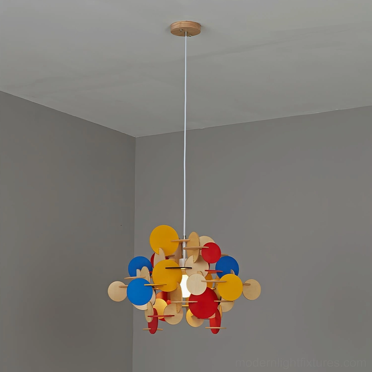 Bau pendant light mixed color wooden discs creating visual depth and sculptural presence