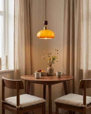 Bead pendant light suspended above wooden dining nook with warm ambient glow and neutral home decor