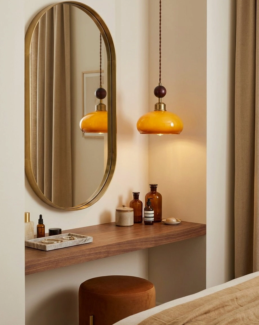 Two matching bead pendant lights illuminating bedroom vanity area with oval mirror and wood-toned interior