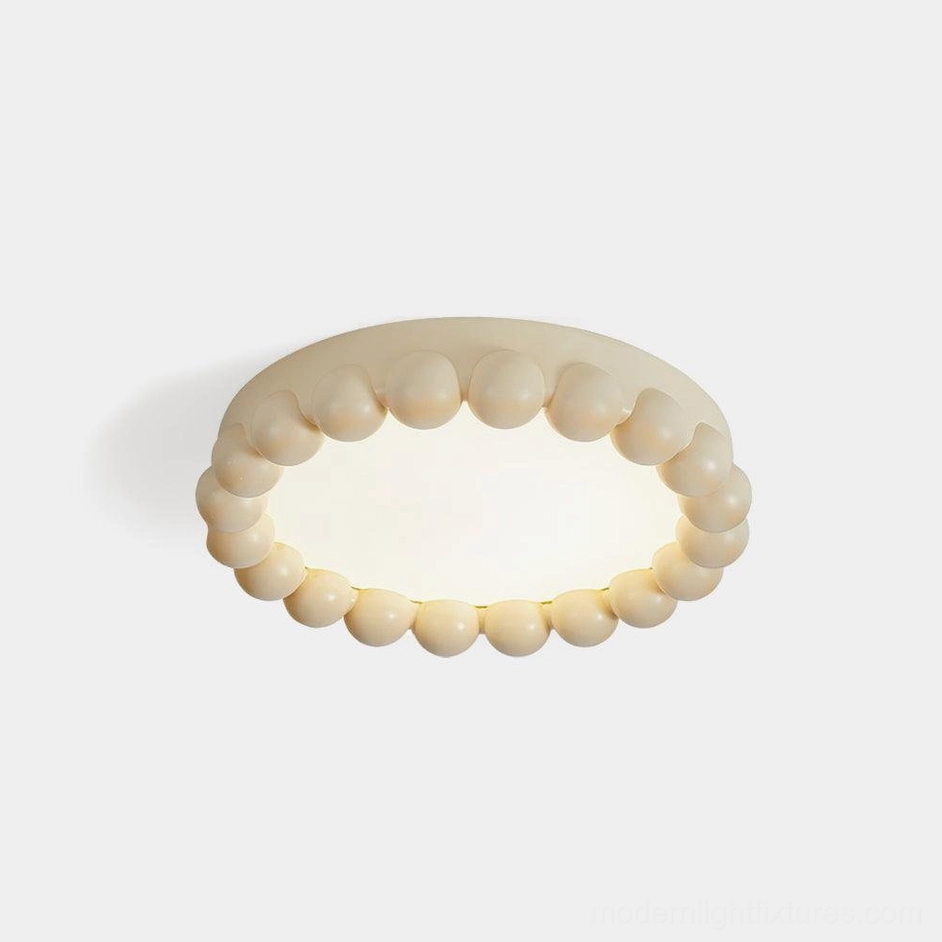 Beaded LED ceiling light with cream finish showing sculptural round bead texture on white background