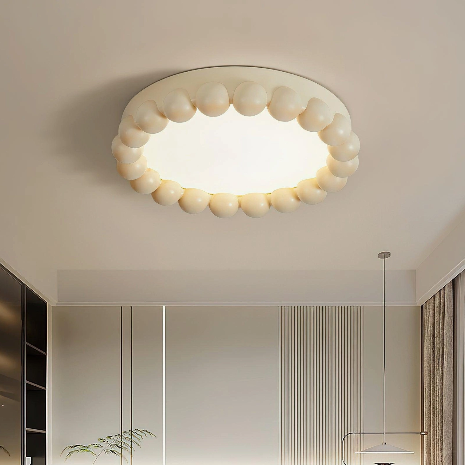 Detail view of beaded ceiling light fixture showing durable resin and acrylic construction