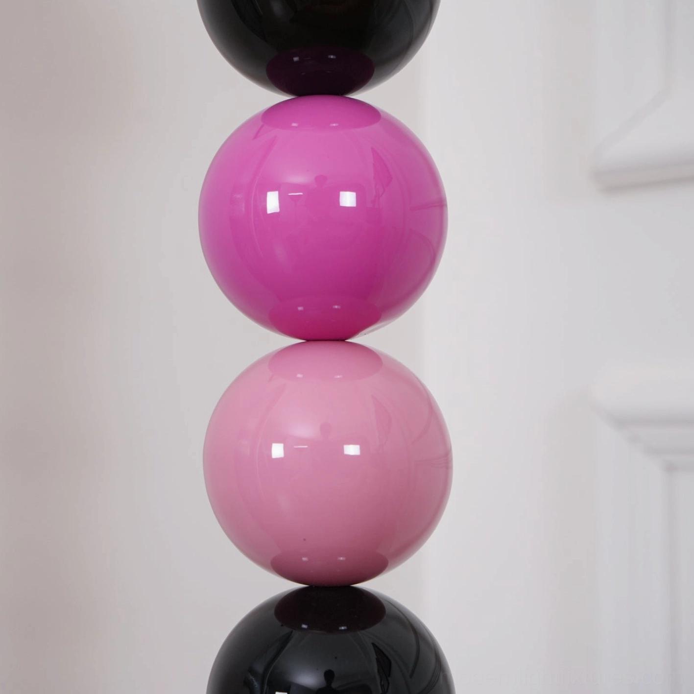 Multi-sphere beaded floor lamp showing color palette options including black, pink, gold, and white tones
