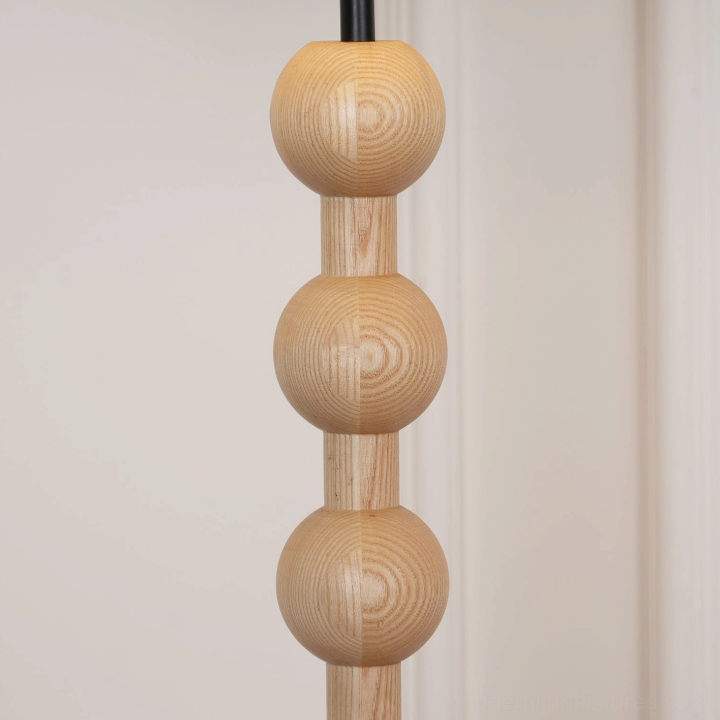 Natural wood beaded floor lamp in contemporary bedroom design setting