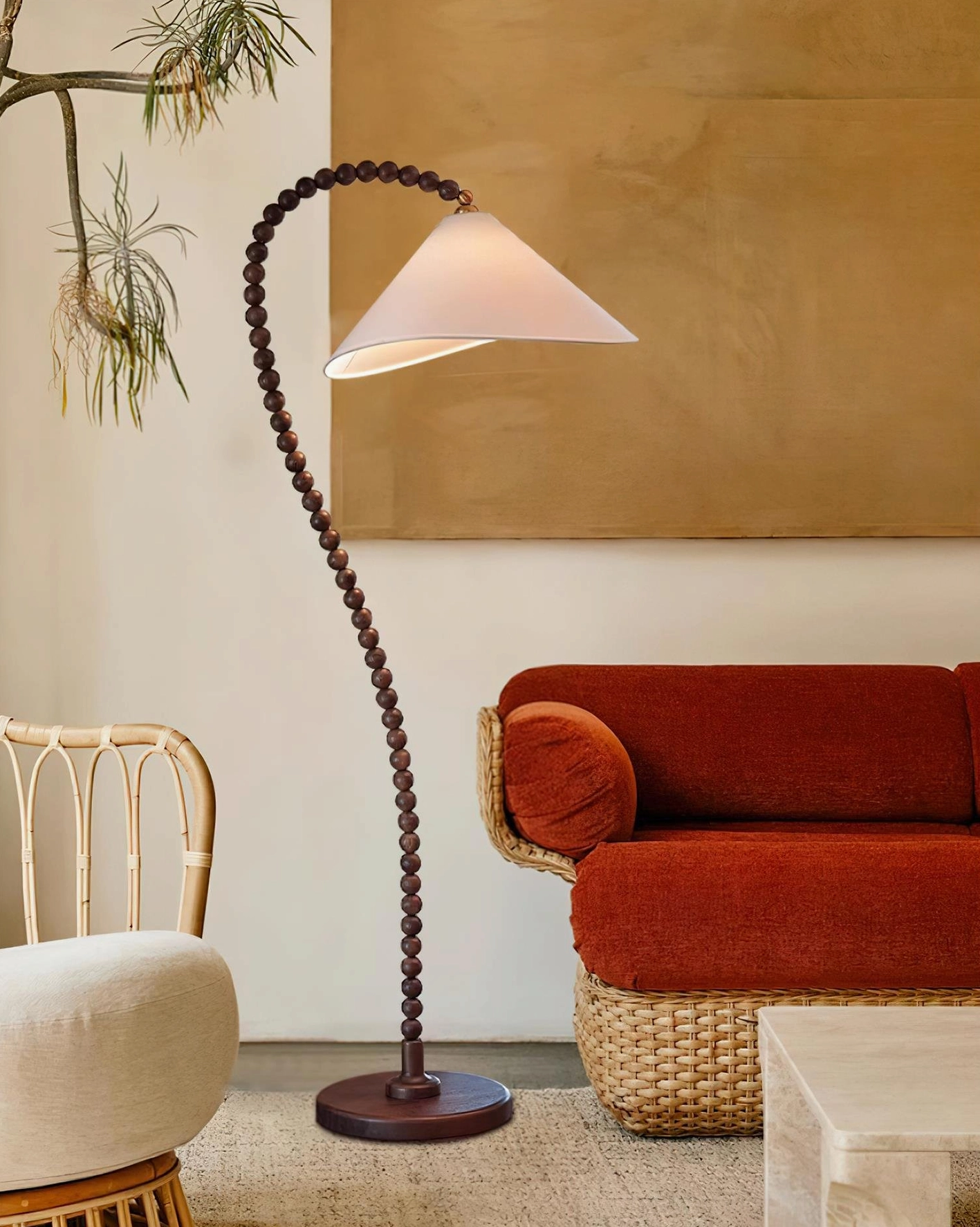 Wooden beaded arched lamp in contemporary living room with burnt orange sofa and rattan furniture