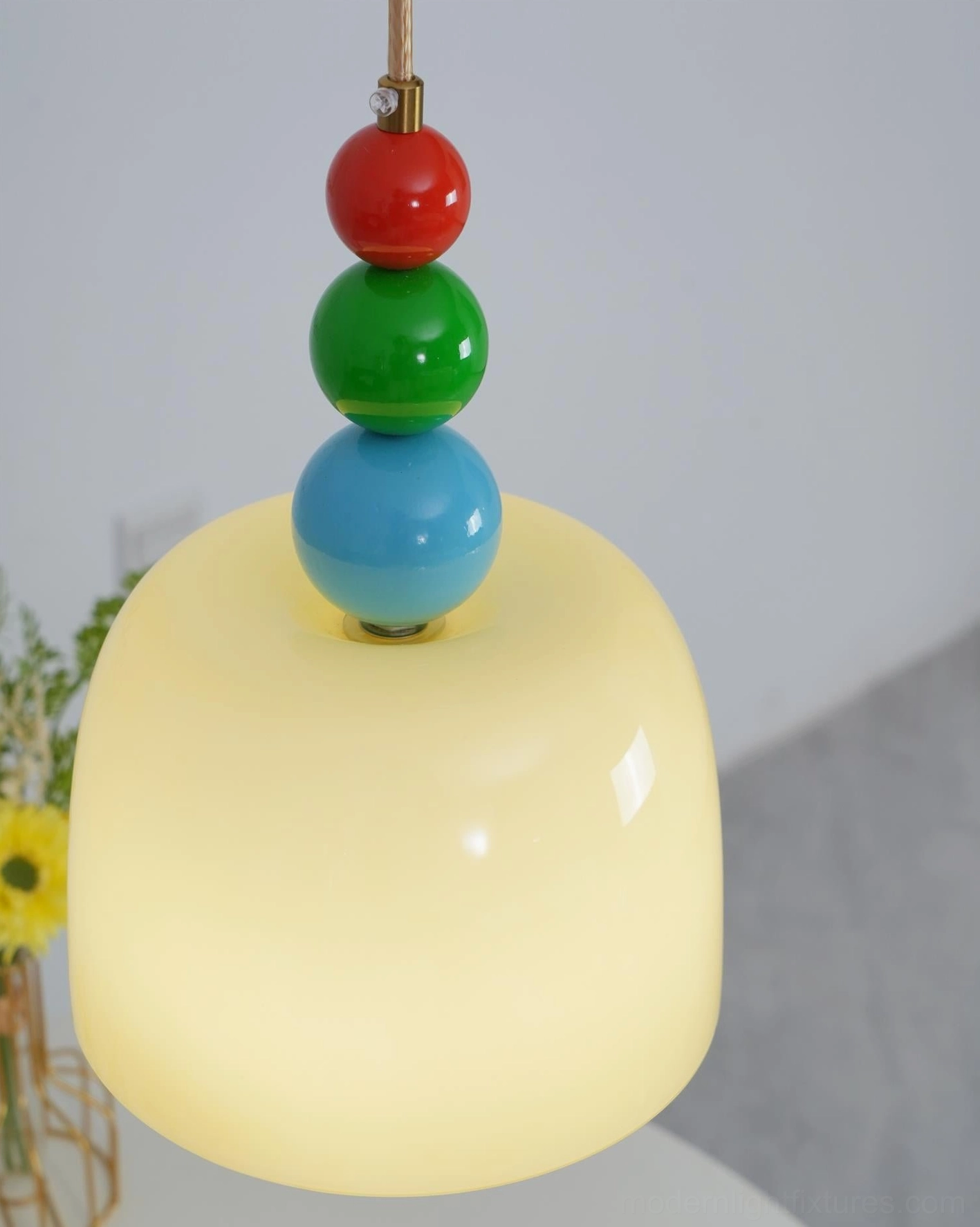 Beaded pendant lamp suspended at optimal height above residential dining area