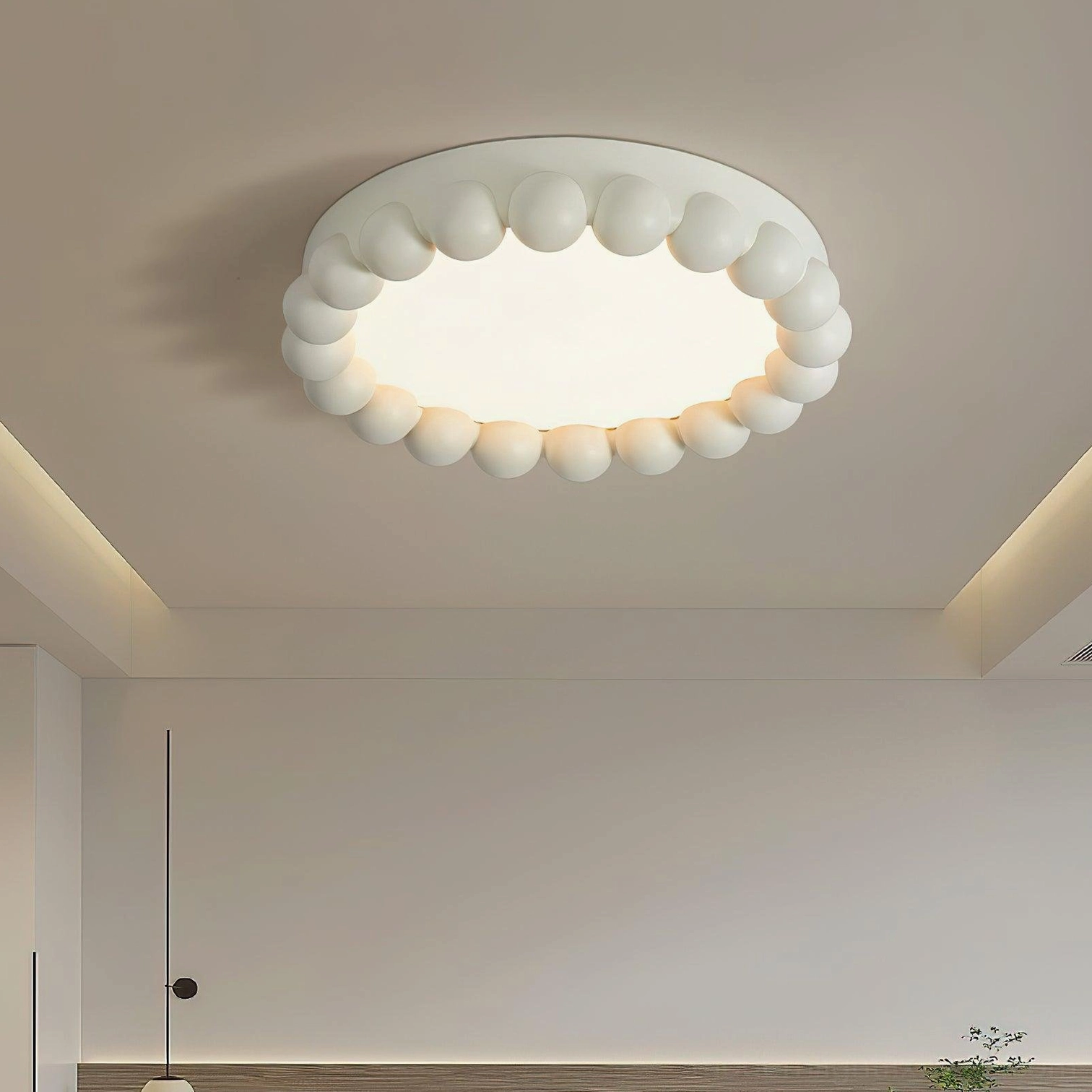 Overhead installation view of beaded recessed ceiling light in modern bedroom with natural lighting