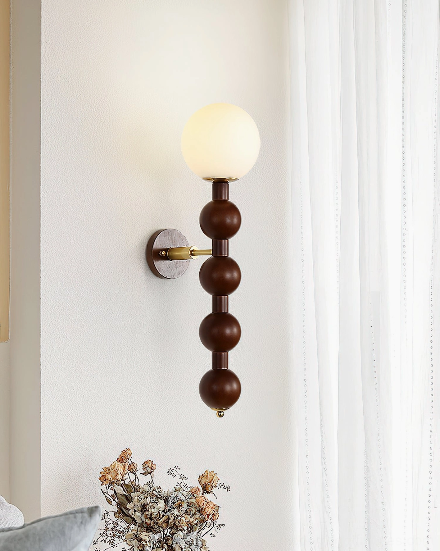 Mid-century modern beaded wall sconce providing warm ambient lighting in residential interior