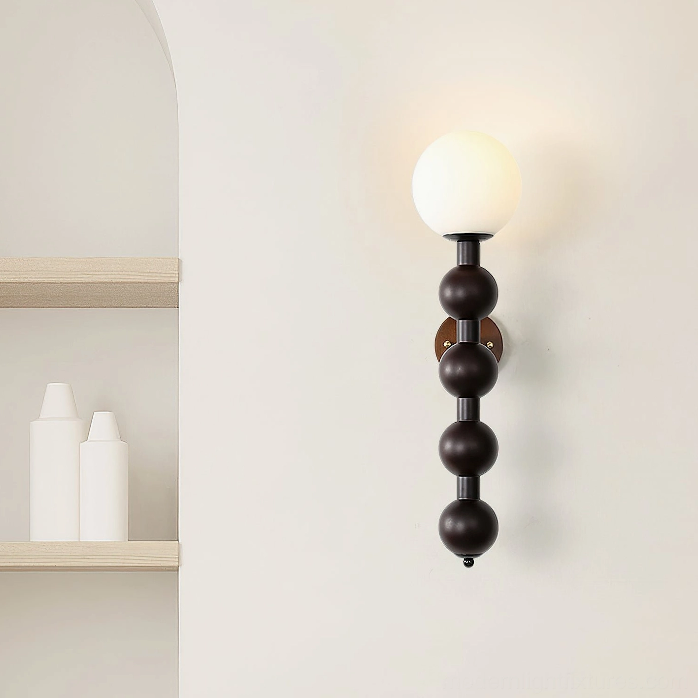 Mid-century modern beaded wall lamp with frosted glass shade in bedroom accent wall