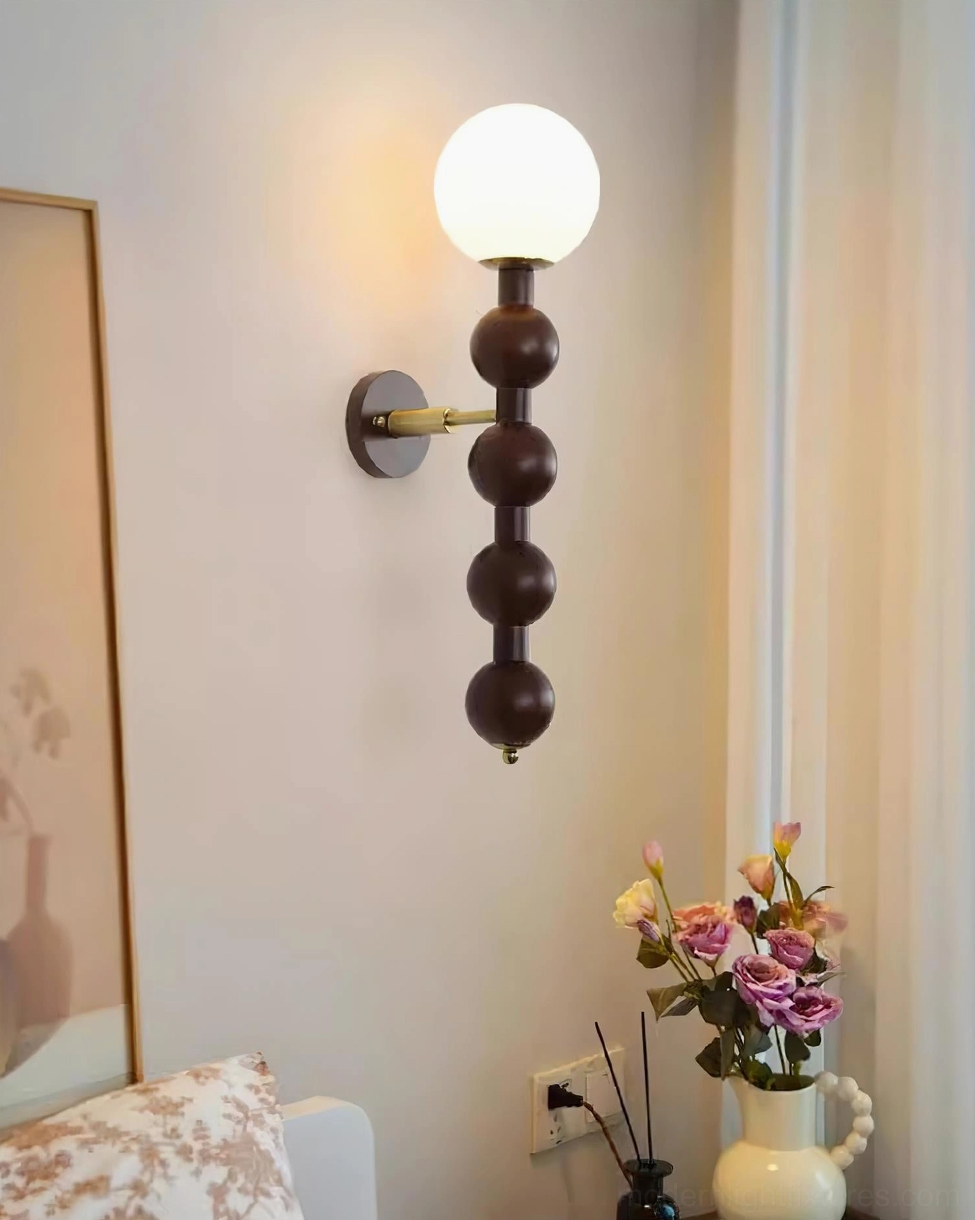 Beaded globe wall sconce in contemporary minimalist interior with clean lines and neutral tones