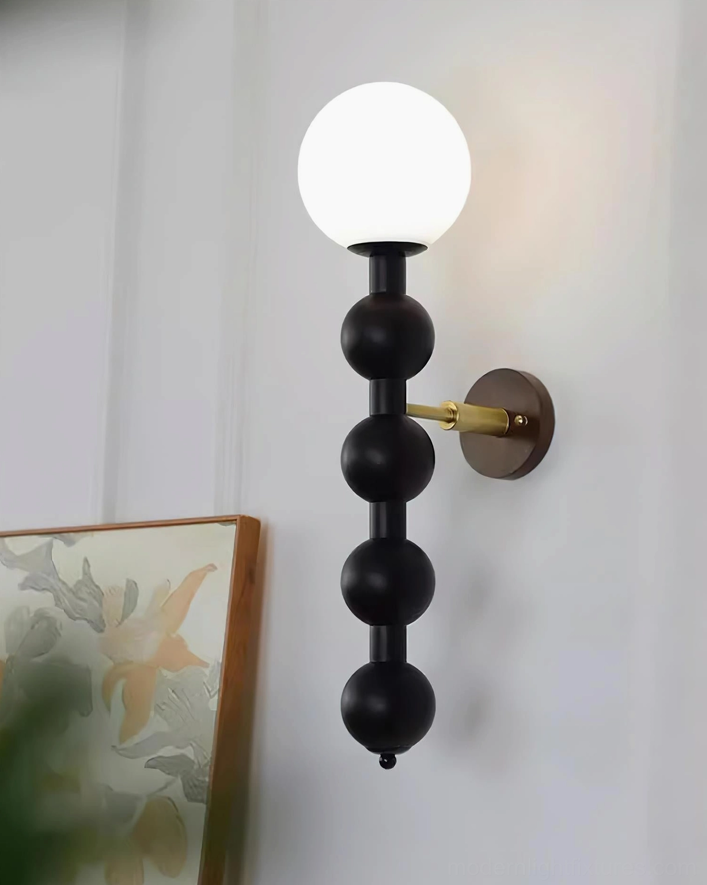 Beaded wall sconce detail shot showing frosted glass diffuser and wooden bead sphere composition