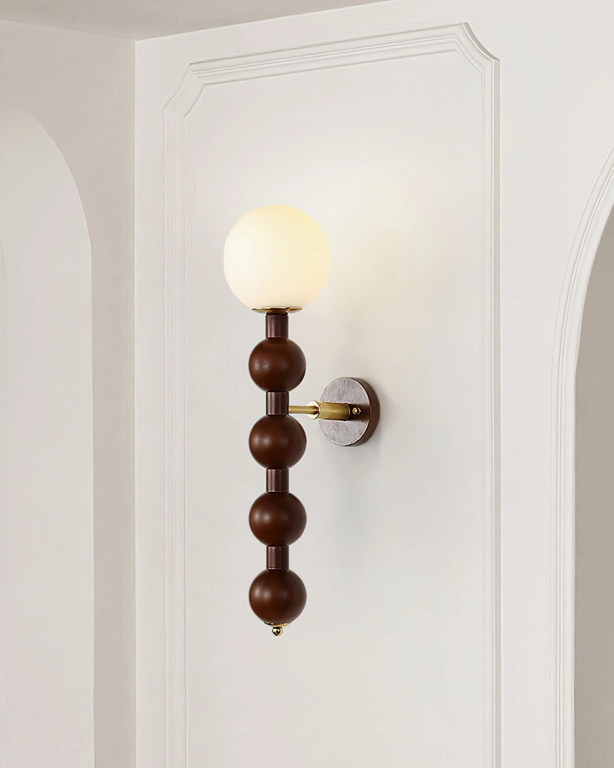 Beaded wall sconce creating dramatic architectural rhythm in residential hallway corridor