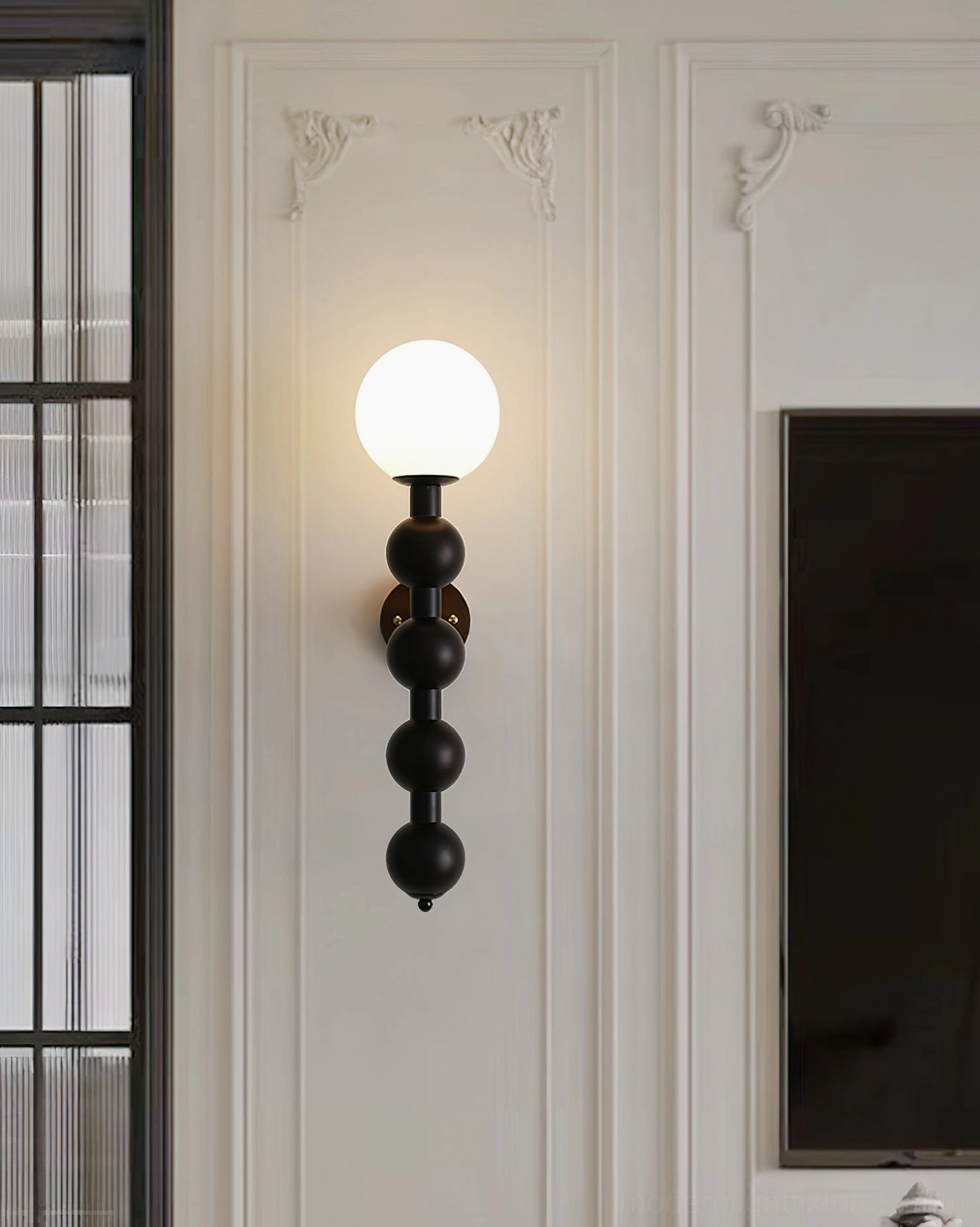 Beaded globe wall lamp demonstrating industrial modern design with exposed brass mounting